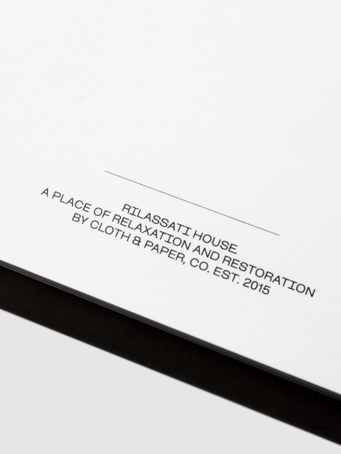 Closeup of notepad's footer text, which reads " RILASATTI HOUSE / A PLACE OF RELAXATION AND RESTORATION / BY CLOTH & PAPER, CO. EST. 2015"