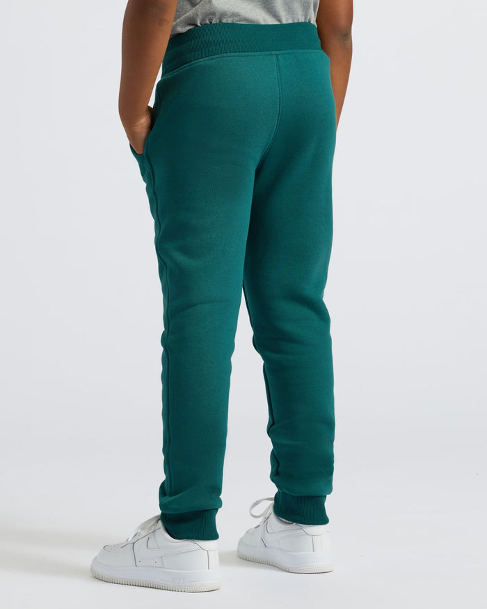 Boys' Deep Emerald Fleece Jogger with white sneakers.