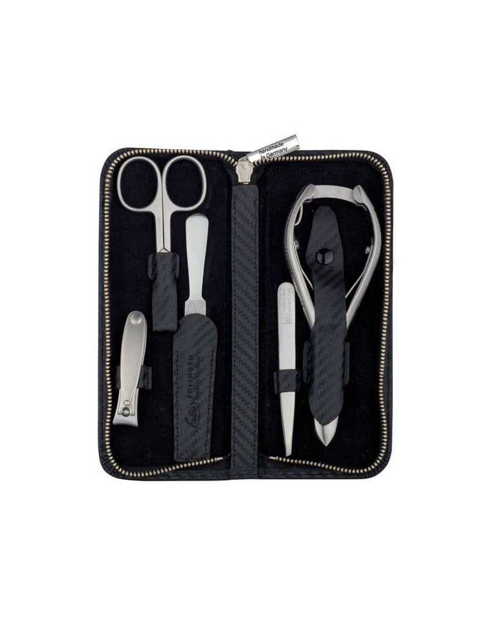 Open black manicure set with scissors, nail clipper, and tweezers