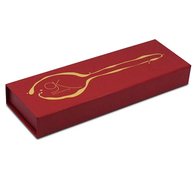 Gray Kunz Spoon Limited Edition in Gold showing red packaging on white background.