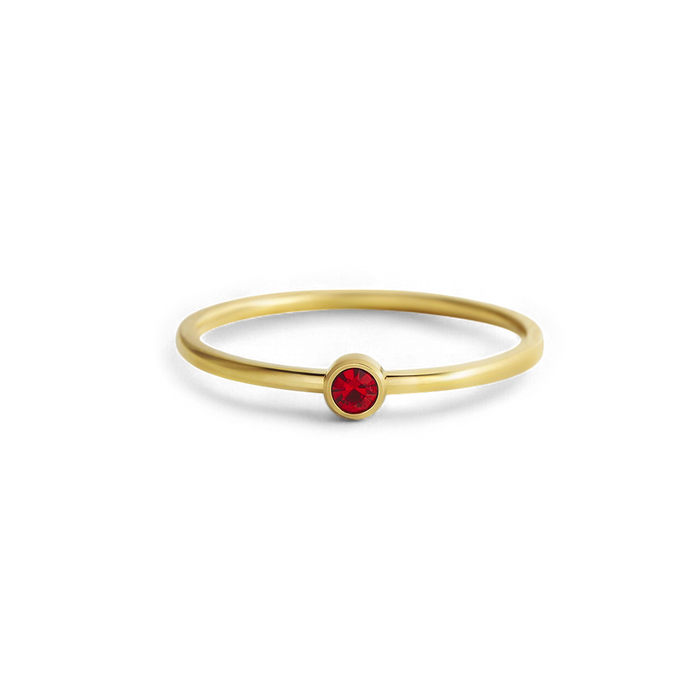 Gold ring with a red gemstone on a white background