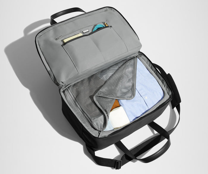 Main interior packed with clothing. Slip pockets packed with a notebook and charging cords
// The Overnight Bag features a detachable padded shoulder strap.